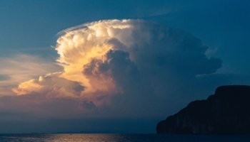 A cloud above the sea at sunset