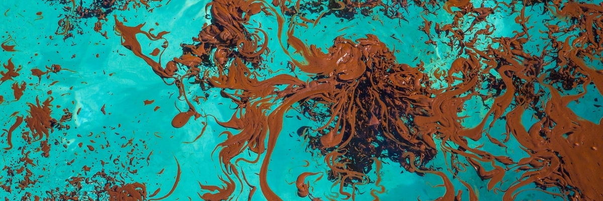 Oil spill in blue water